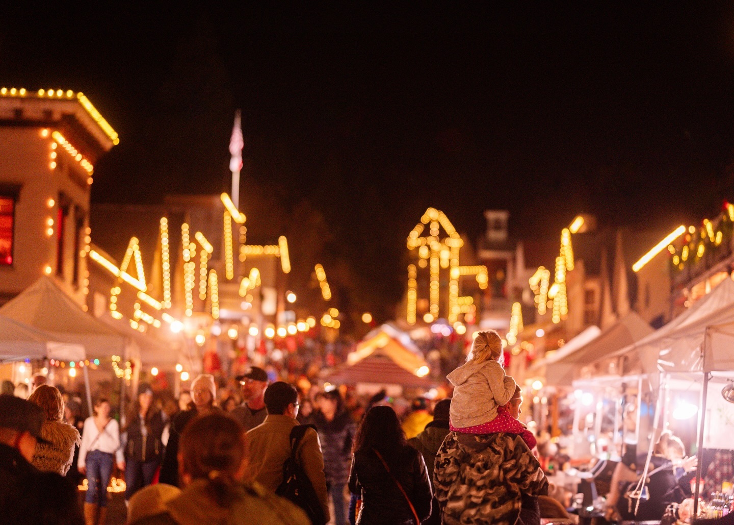 Gas lamps lit on Broad Street during Victorian Christmas